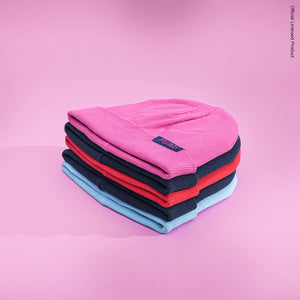 Stack of Fan Ink 3000 Beanies on a pink background.